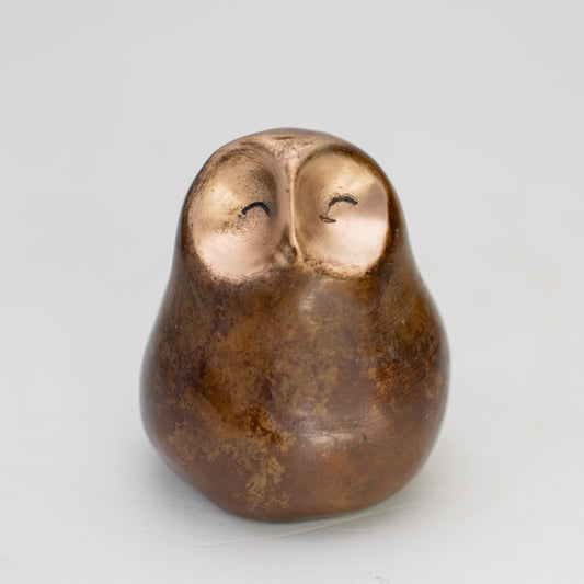 Small bronze owl with a happy facial expression