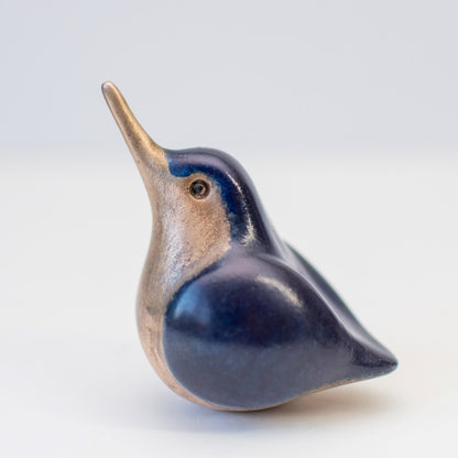 A small, foundry cast bronze kingfisher sculpture