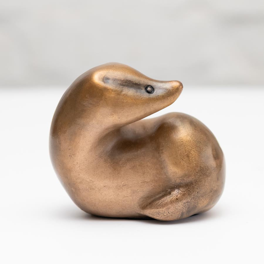 Small Bronze Curvy Badger Sculpture with a smooth, shiny finish and a small black eye
