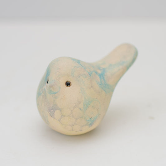 Small ceramic bird with black eyes and a bubble glaze