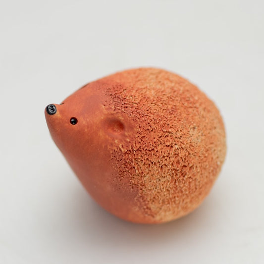 Brown ceramic hedgehog with a black shiny nose