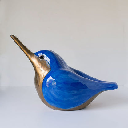 A bright blue and gold ceramic Kingfisher sculpture