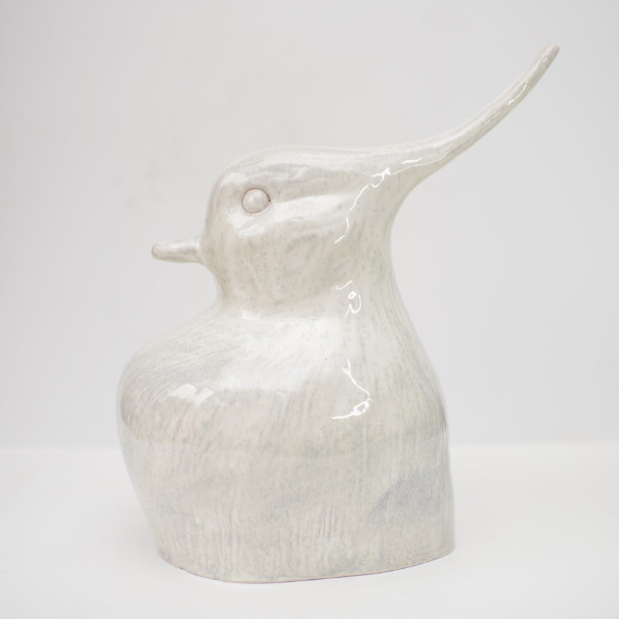 Ceramic lapwing sculpture in a metallic white glaze.