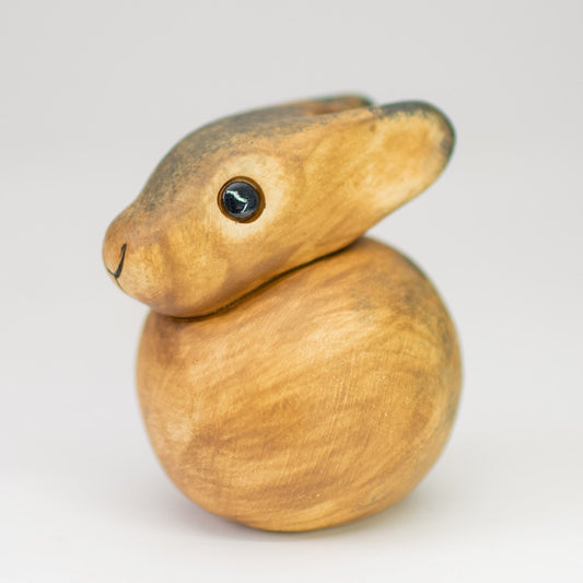 Small ceramic Leveret, a baby hare sculpture in a watercolour effect brown underglaze with big black eyes and white tail