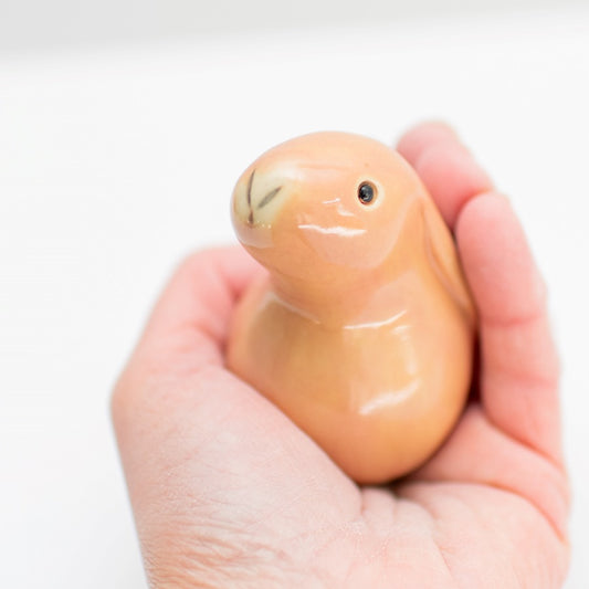 Dusky Pink Ceramic Bunny held in a hand