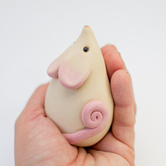Small White Ceramic Mouse Sculpture held in a hand