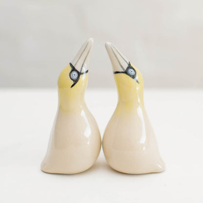 Small Ceramic Gannet Sculpture Set, two yellow and white ceramic birds with black eyes and beaks