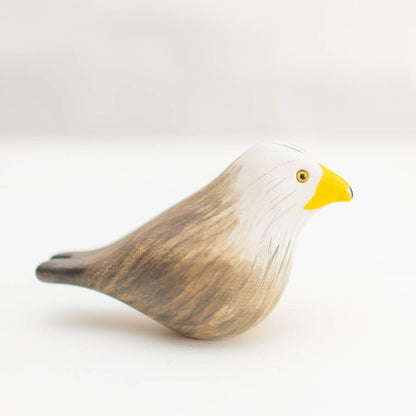 Ceramic Red Kite, a small bird figurine with a white head, yellow beak, and brown body