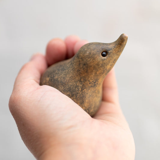Small ceramic shrew held in a hand