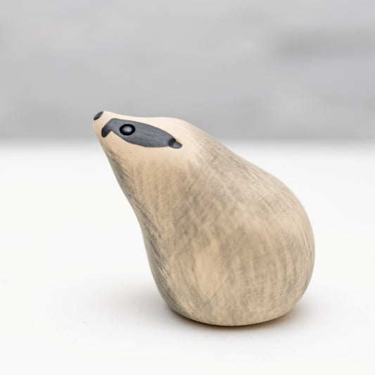 Small ceramic badger sculpture against a white background