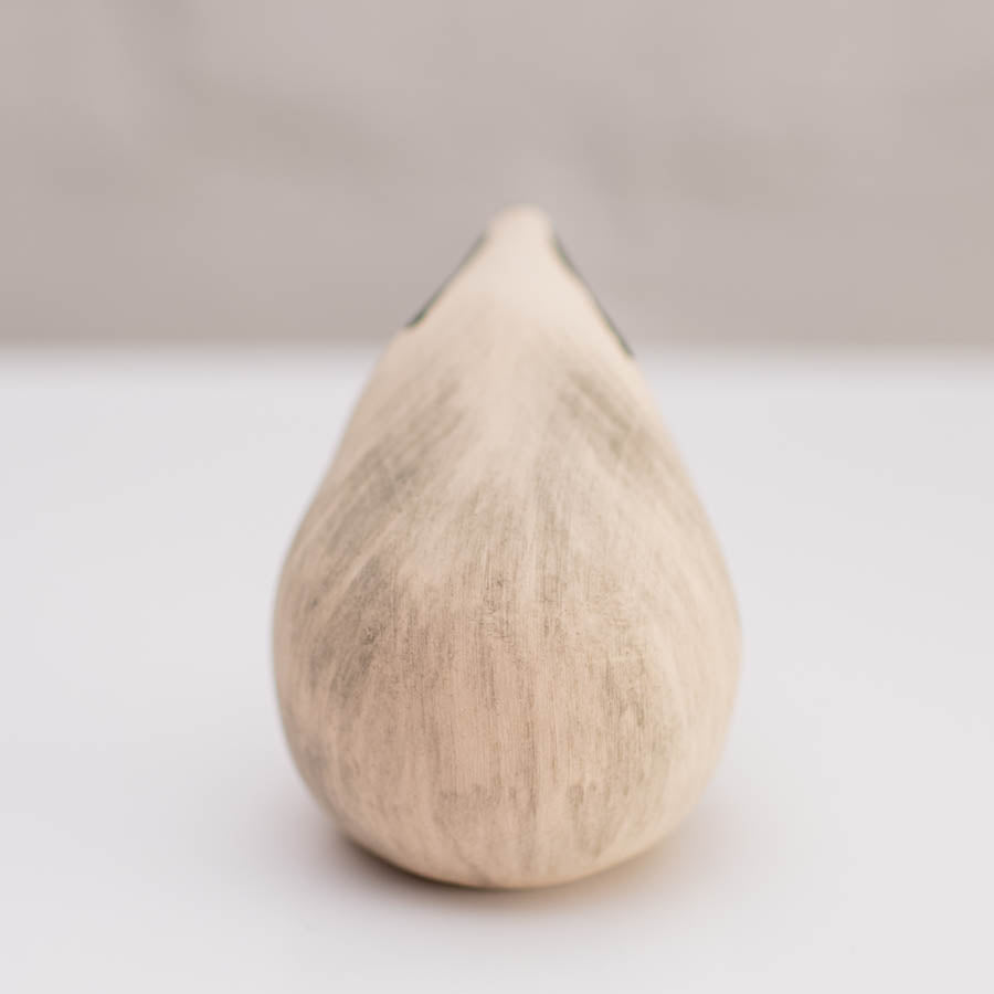 A small badger sculpture against a white background