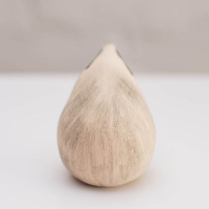 A small badger sculpture against a white background