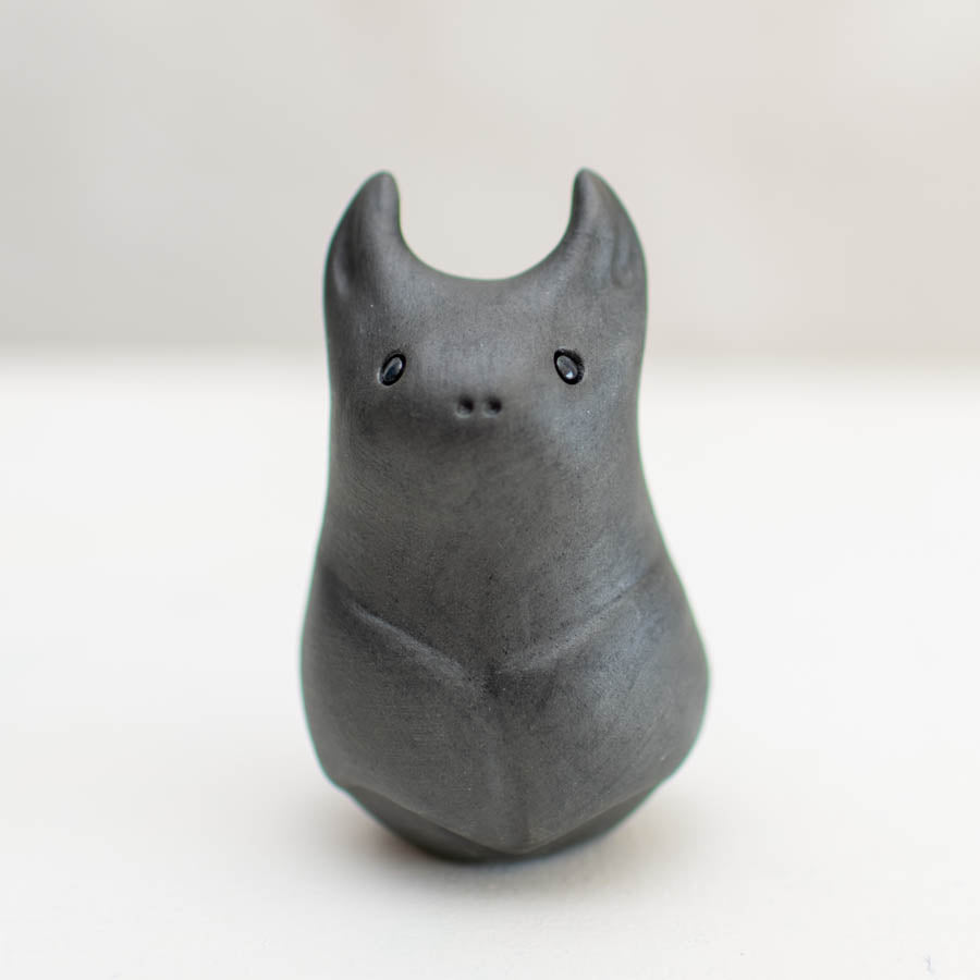 Small Ceramic Bat Sculpture, dark grey with small ears, eyes, and nose