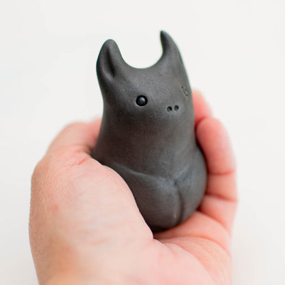 Small Ceramic Bat Sculpture held in a hand
