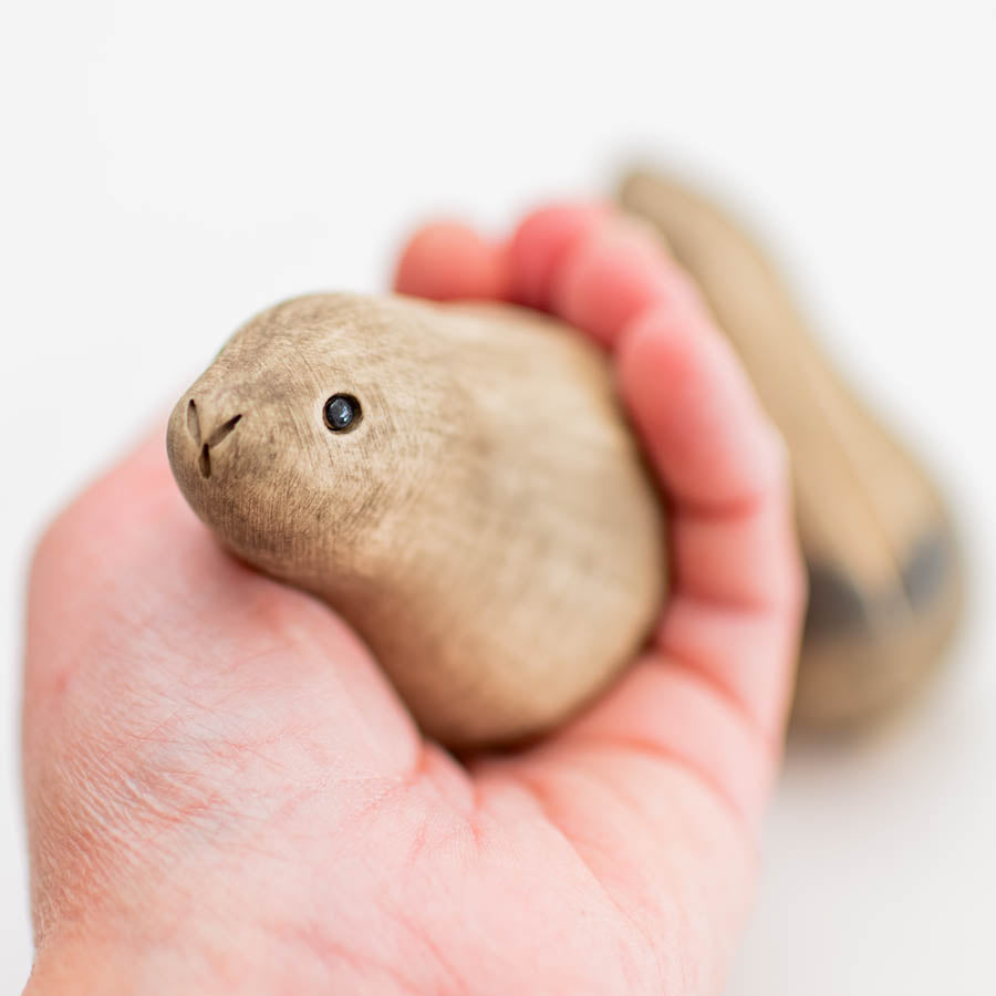 Kissing Ceramic Hares Gift Set, a small ceramic hare with a black eye and a small nose, held in a hand