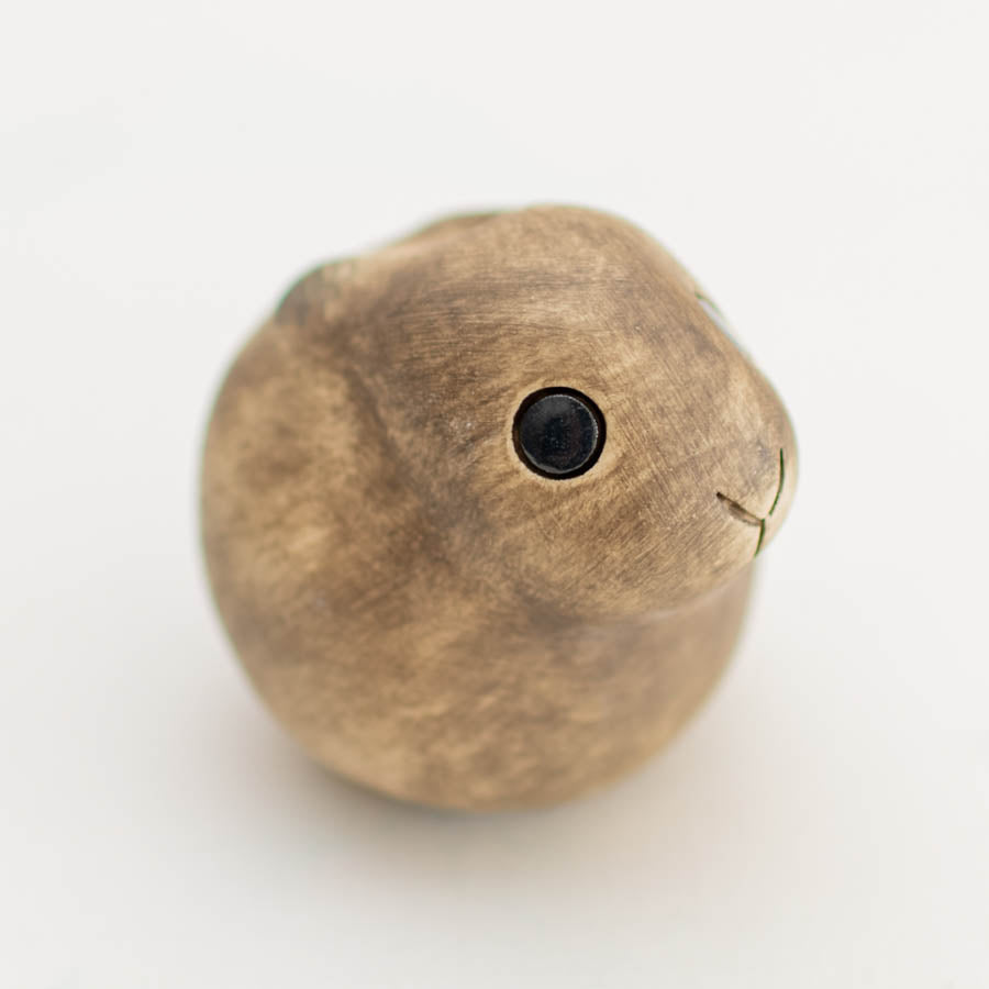 Small ceramic Leveret Sculpture, light brown with black eyes and etched mouth