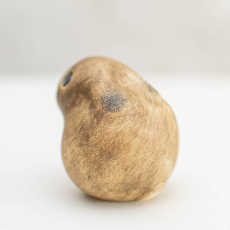 Small ceramic Leveret Sculpture, light brown with dark brown markings, viewed from the side