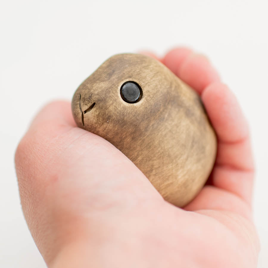 Small ceramic Leveret Sculpture held in a hand