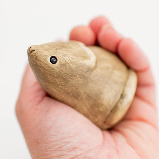 Small ceramic field mouse sculpture held in a hand