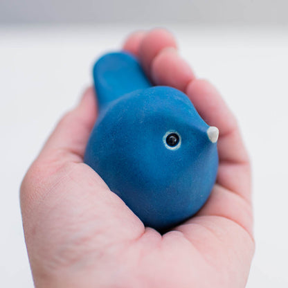 Small Ceramic Bird - Sea Blue held in a hand