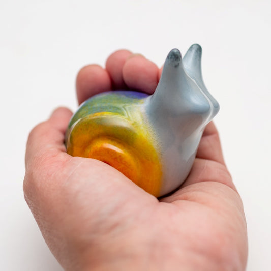 Ceramic Rainbow Snail Sculpture held in a hand