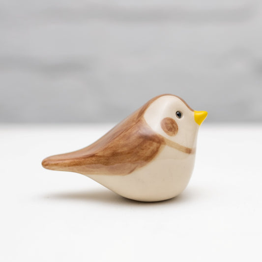 Small Ceramic Snow Bunting, a brown and white ceramic bird with a yellow beak