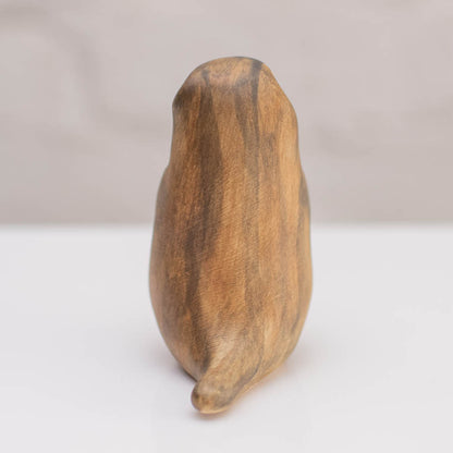 A small ceramic stoat sculpture against a grey backdrop