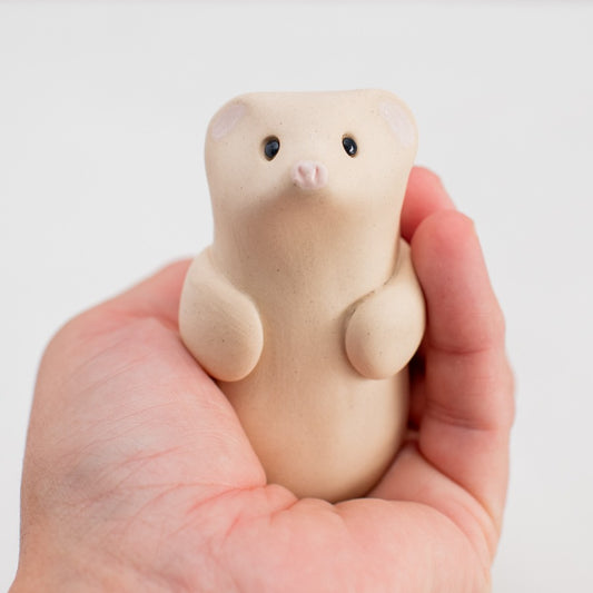 Ceramic Ermine Stoat Sculpture held in a hand