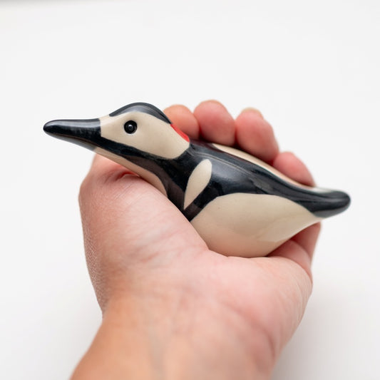 Ceramic Woodpecker Sculpture held in a hand