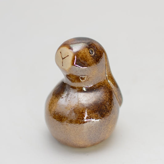 Small ceramic bunny sculpture in a brown metallic glaze