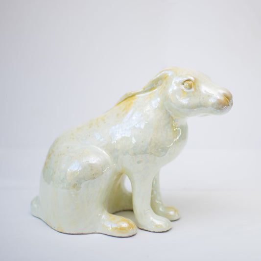 A sitting ceramic hare sculpture in a glossy, sparkly cream finish.