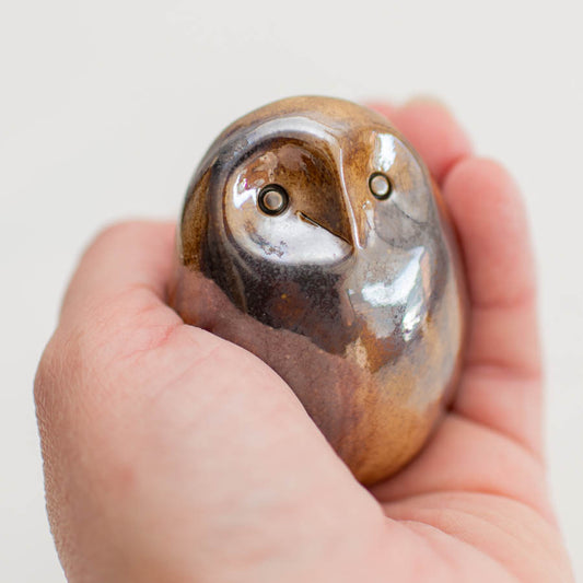 Mini Metallic Owl Sculpture held in a person's palm