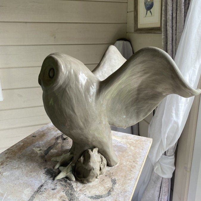 large Owl sculpture in clay in the studio