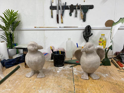 Two clayPuffins on a workbench