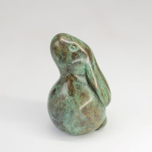 Small bronze bunny rabbit sculpture in a traditional green patina with shiny metallic eyes.