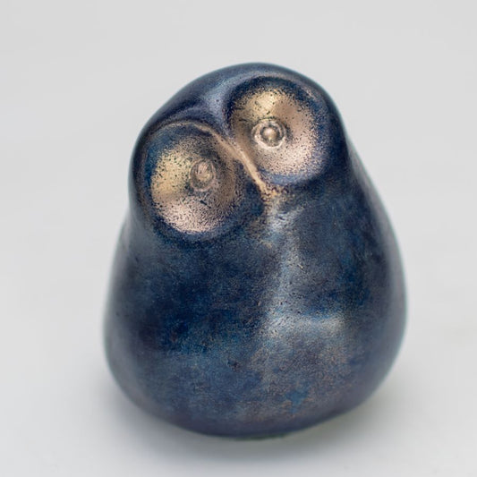 Smooth, small blue owl figurine made from bronze